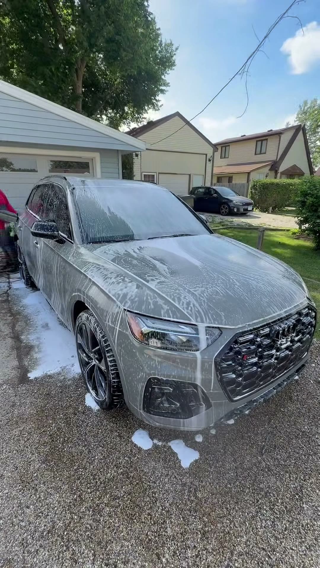 Gray Audi SUV covered in foam in a driveway