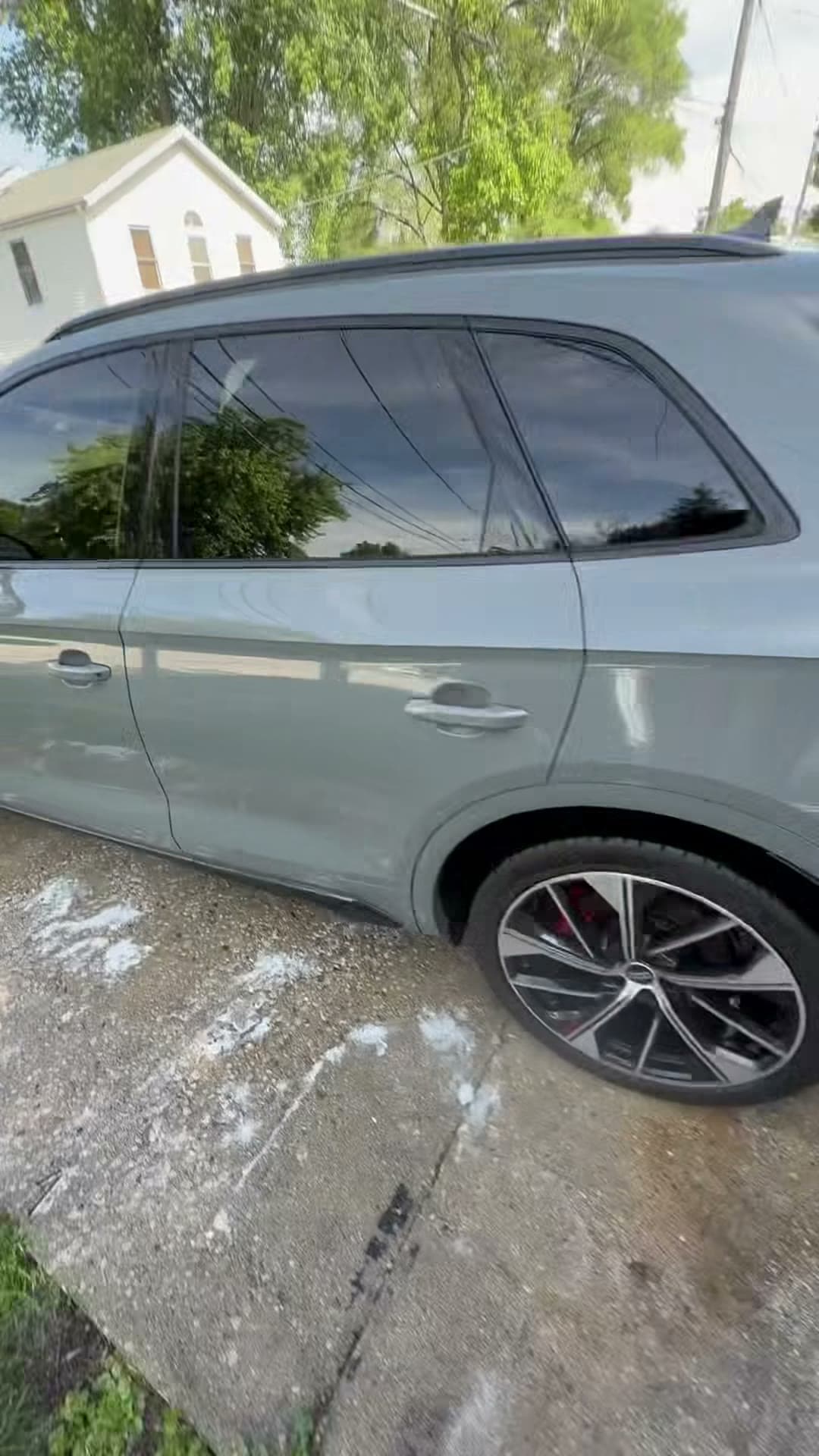 Clean gray Audi SUV viewed along the rear body line