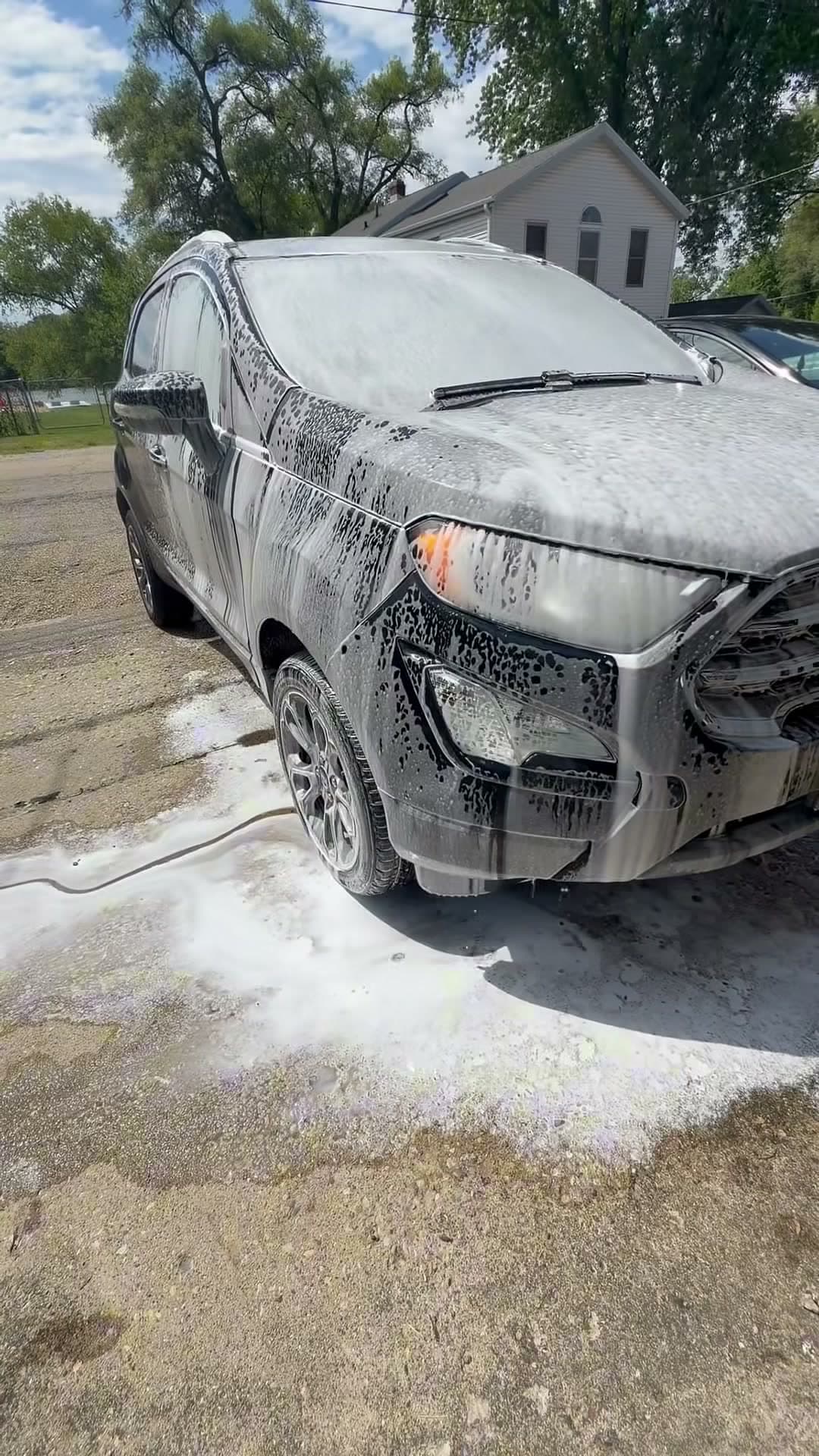 Ford Explorer covered in foam during the exterior wash