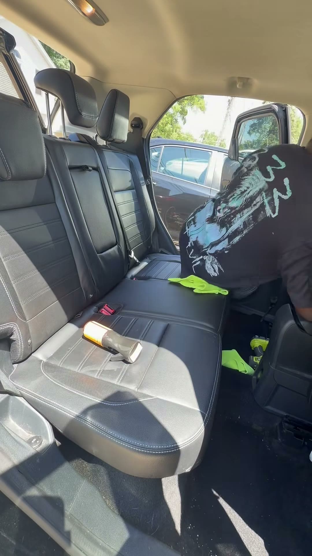 Detailer wiping the rear seats of a Ford Explorer