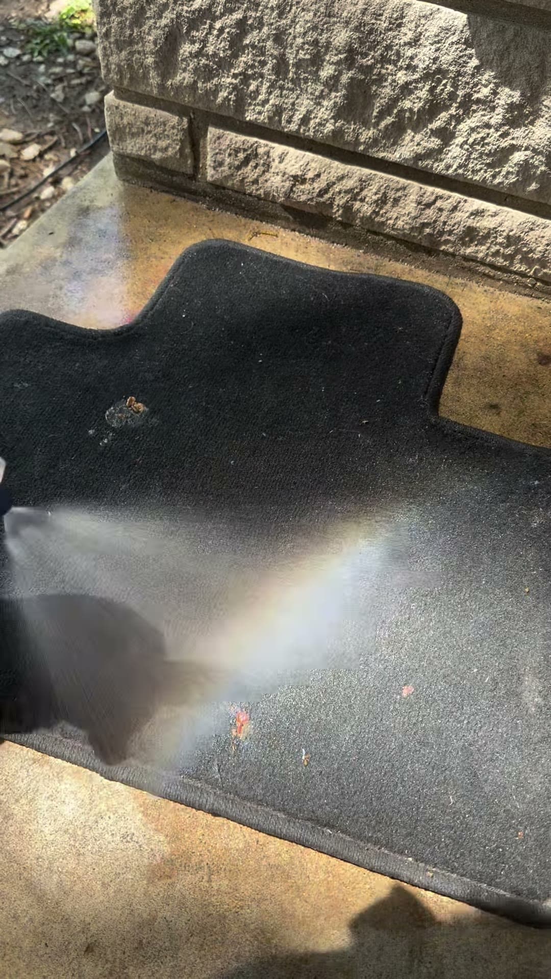 Vehicle floor mat with visible spots before focused cleaning