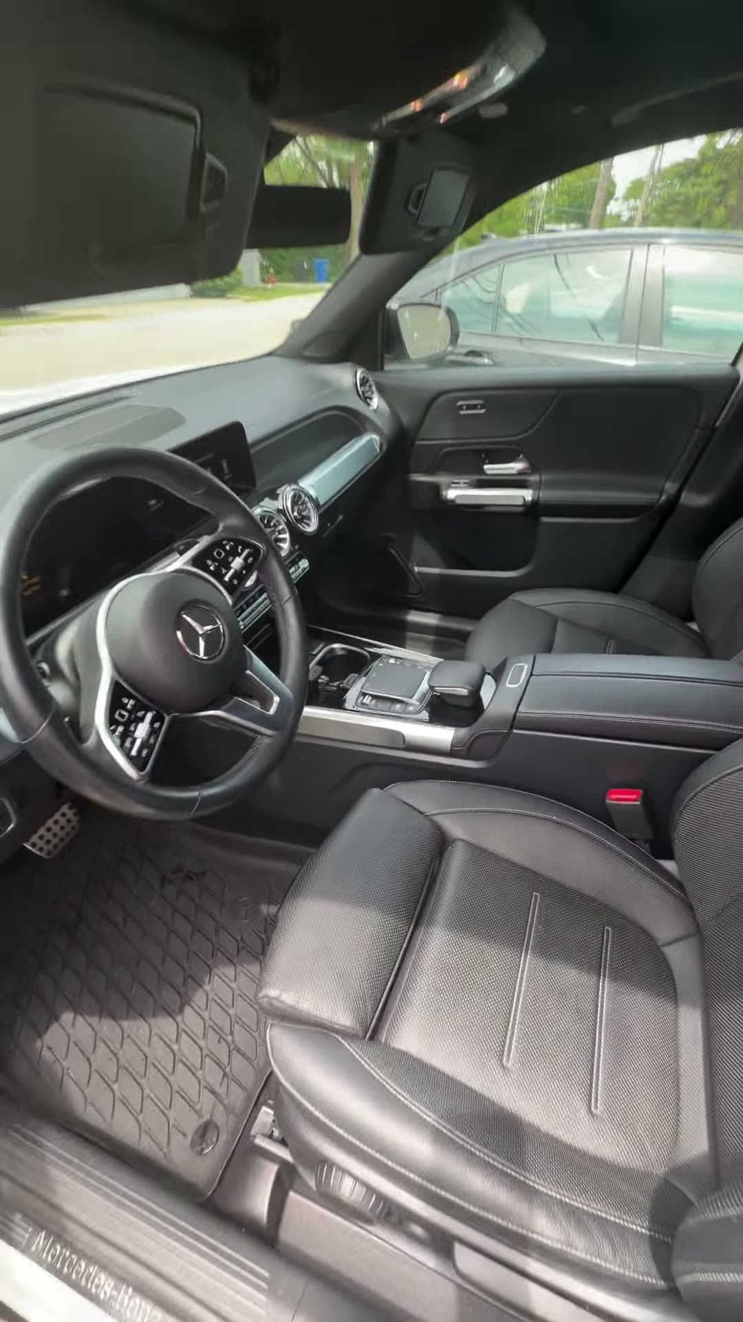 Clean black cabin inside a white Mercedes SUV